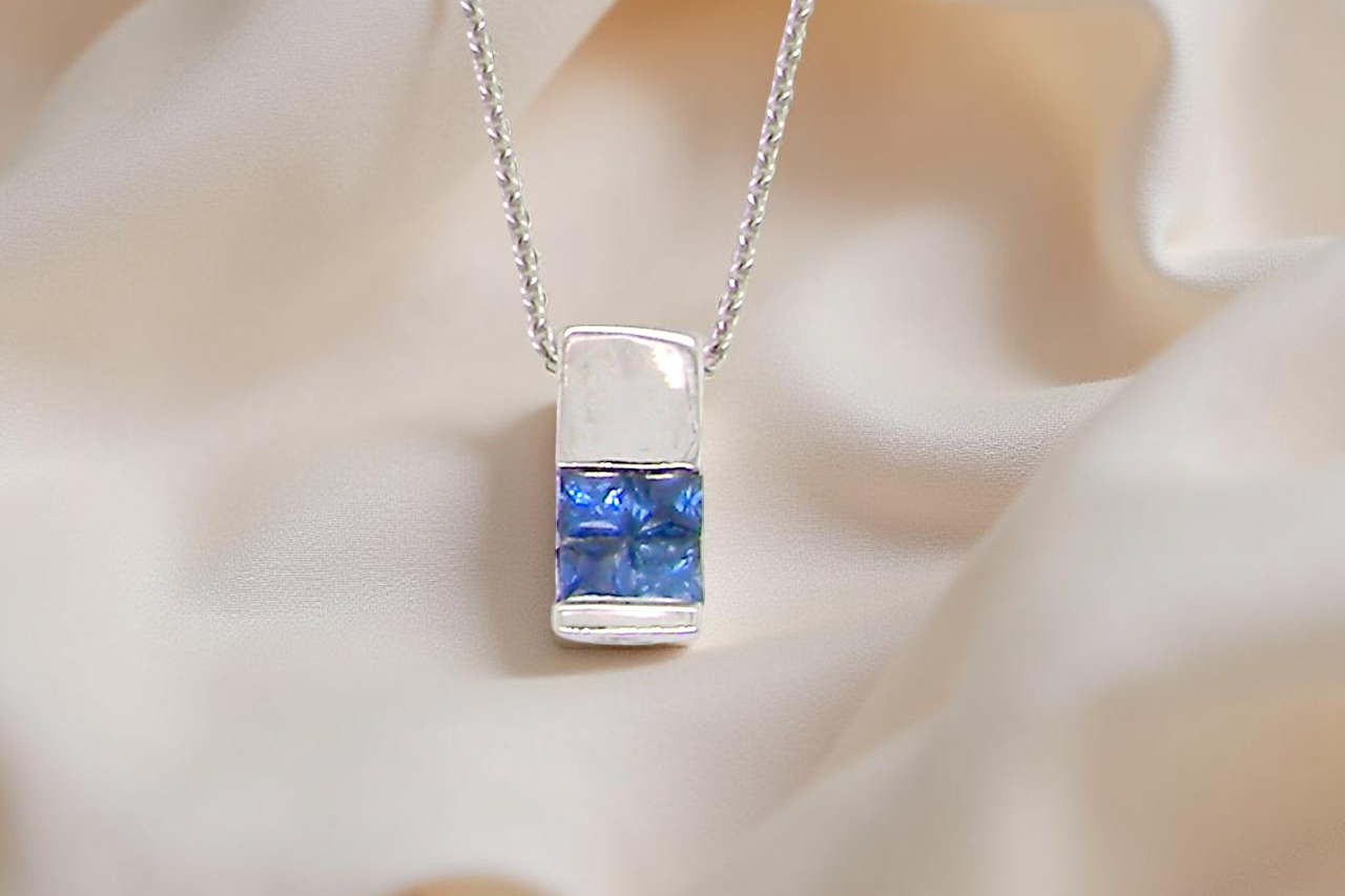 An 18 carat White Gold* Pendant with Sapphires