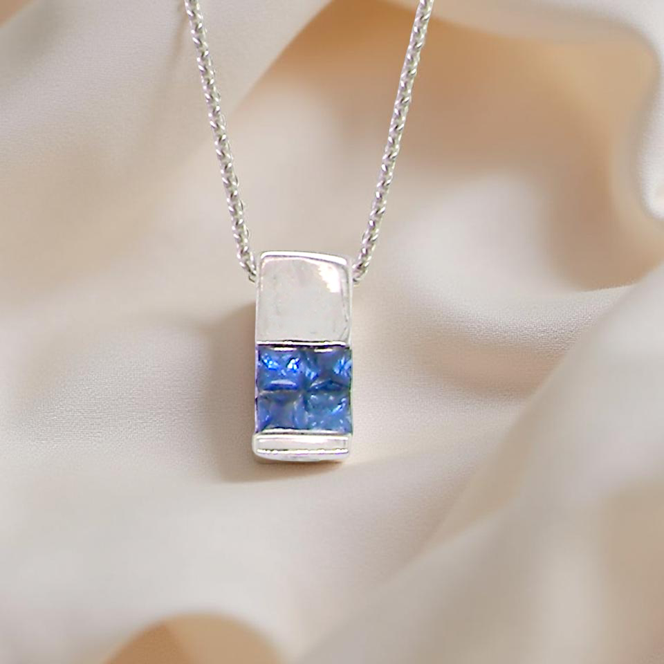 An 18 carat White Gold* Pendant with Sapphires