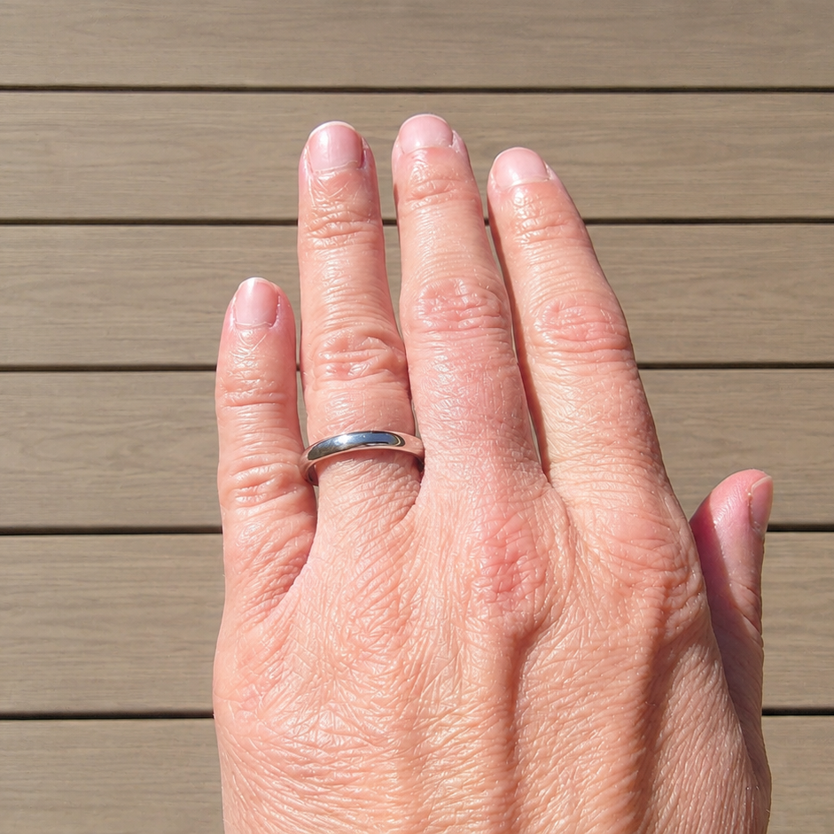 White gold 3mm wedding band on a hand