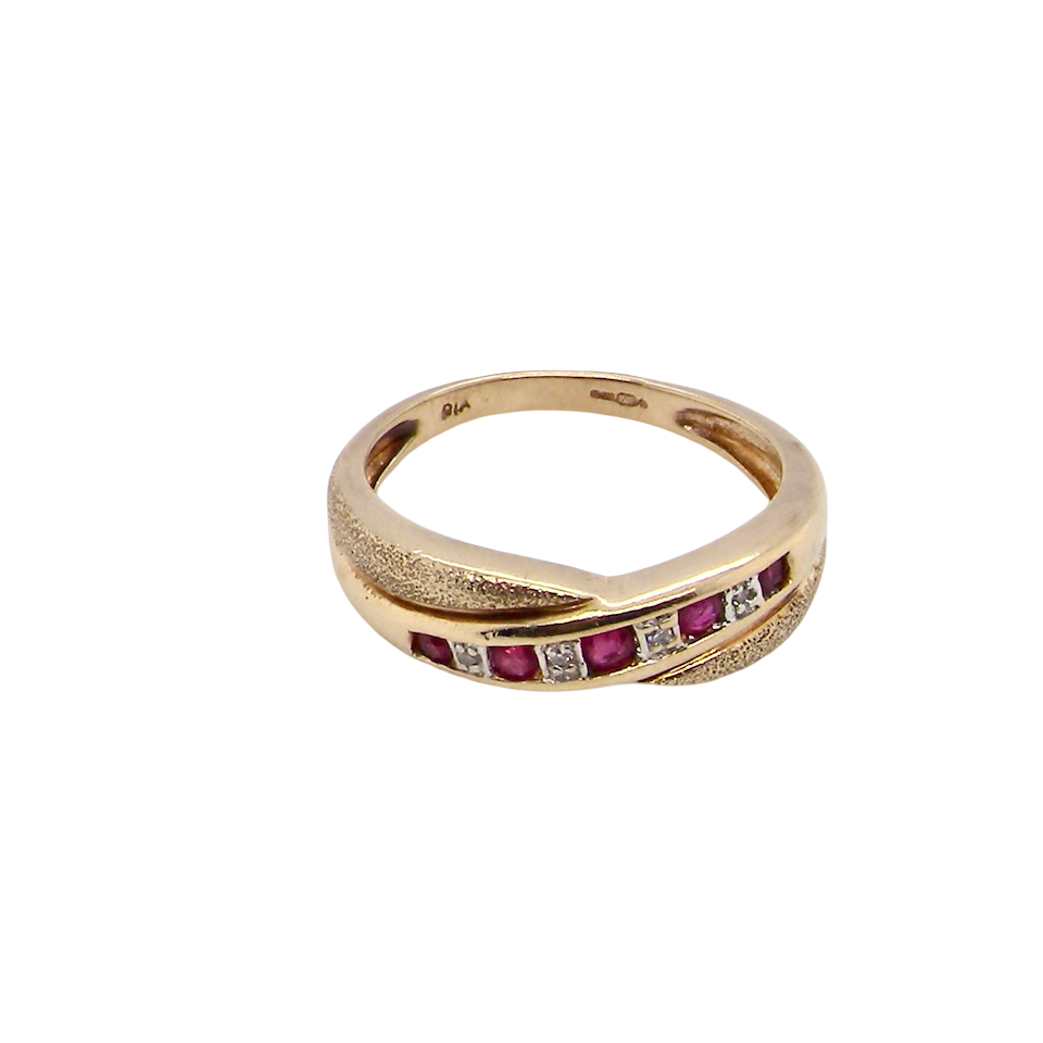 above A 9 carat gold half hoop eternity ring. Set with five calibre cut rubies, from 1.7 to 2mm, and between small 1mm white diamonds.