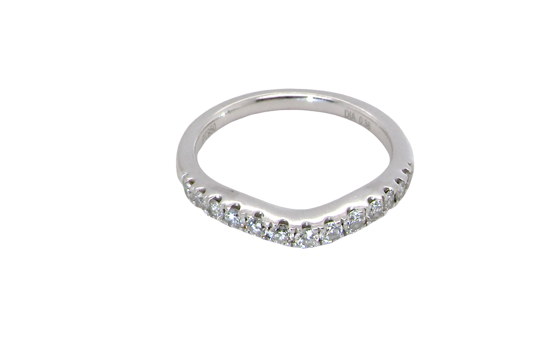 above A Platinum half hoop ring featuring a gently contoured U-shaped centre, designed to allow a cluster or solitaire ring to sit comfortably alongside.