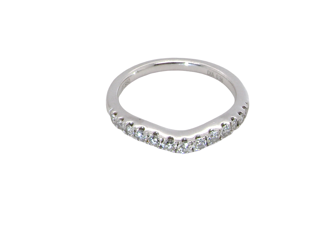 above A Platinum half hoop ring featuring a gently contoured U-shaped centre, designed to allow a cluster or solitaire ring to sit comfortably alongside.