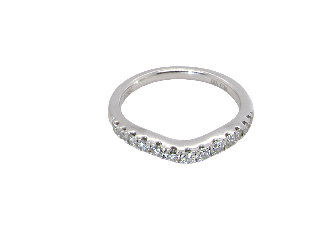 above A Platinum half hoop ring featuring a gently contoured U-shaped centre, designed to allow a cluster or solitaire ring to sit comfortably alongside.