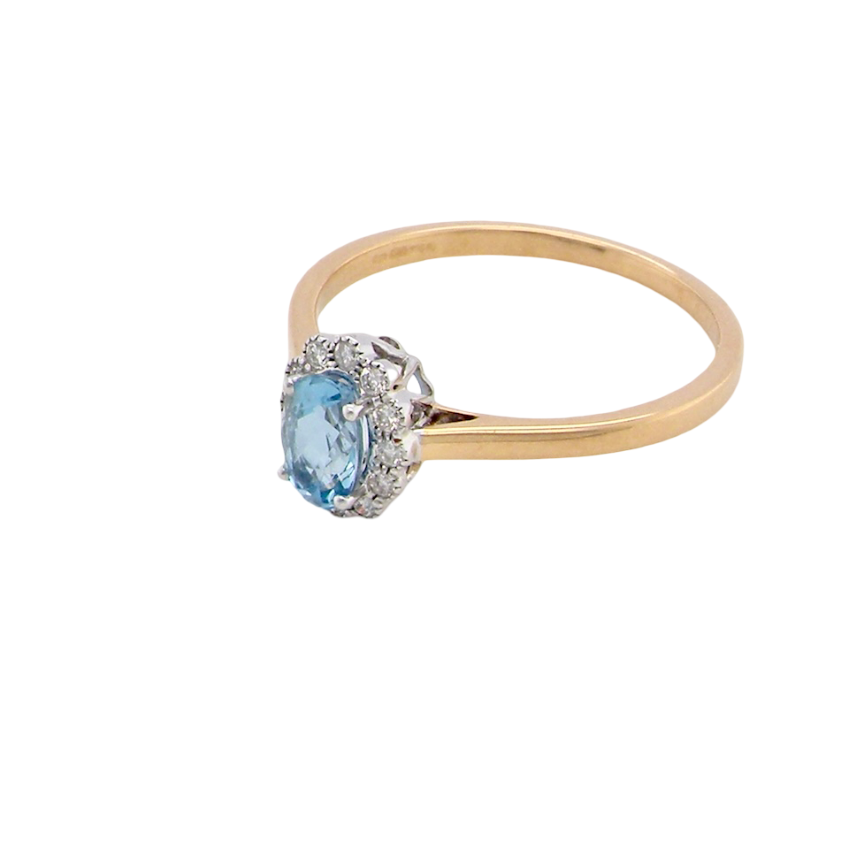 above An 18 carat gold cluster ring. Set to the centre a lovely ice blue aquamarine 6x4mm, claw set.