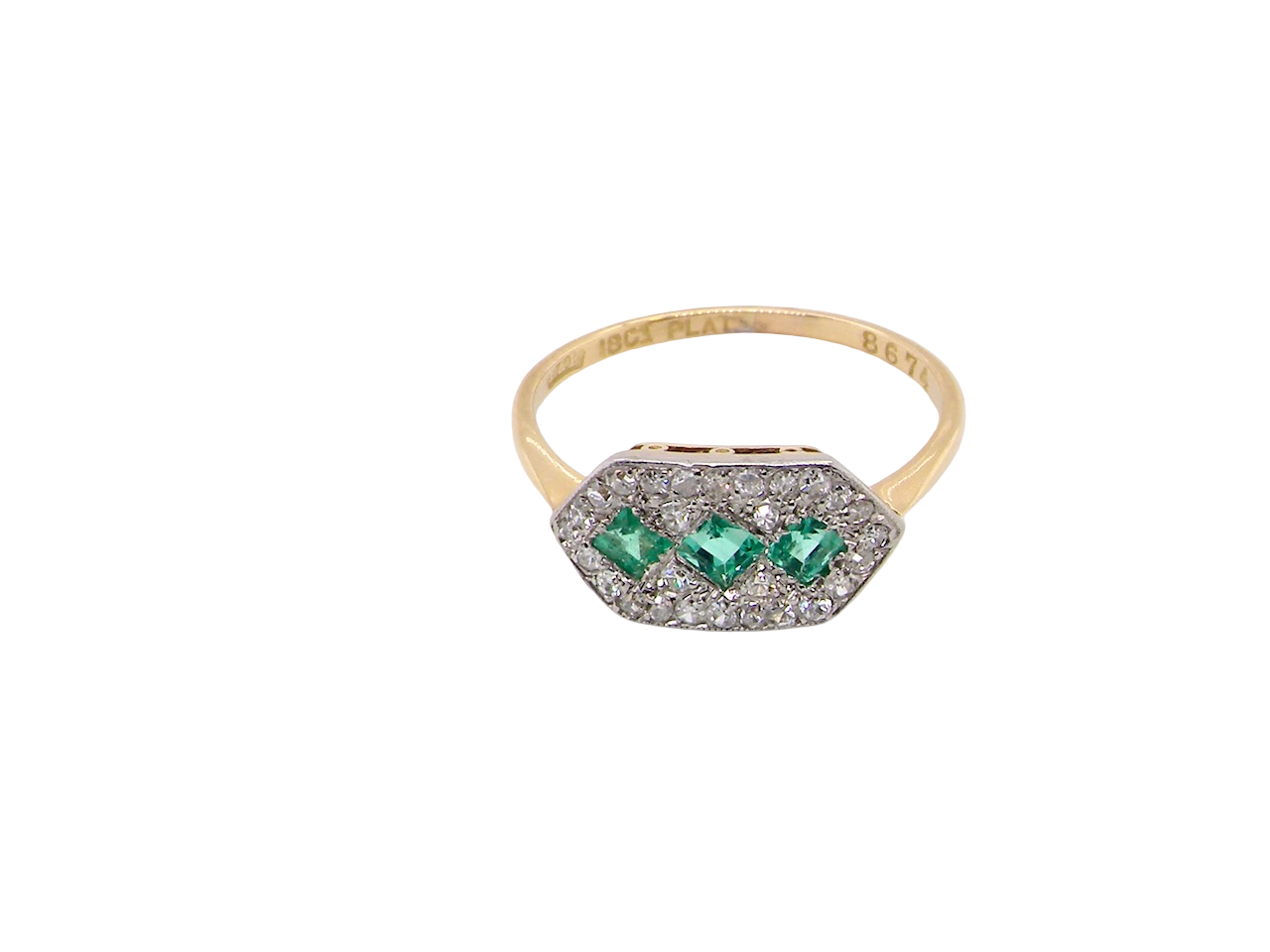 above fine Edwardian era cluster ring, beautifully handcrafted with a trio of vibrant emeralds surrounded by a halo of antique old-cut diamonds.