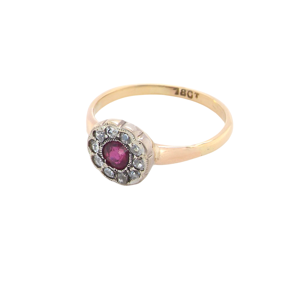 angle view A very pretty vintage daisy cluster ring. Features to the centre a round pink red ruby that measures 4mm, and is mille grain set.