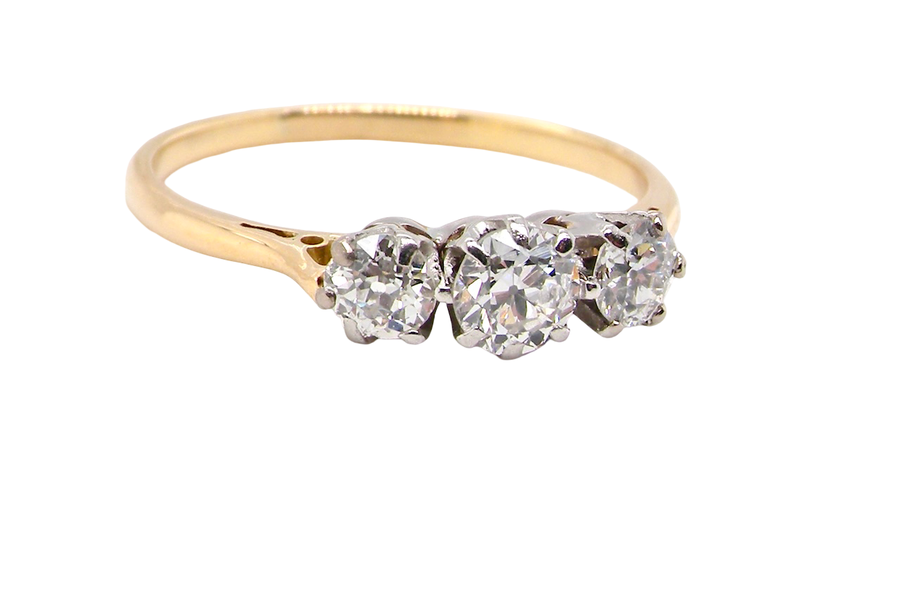 Gold ring with three heart-shaped diamonds on a white background