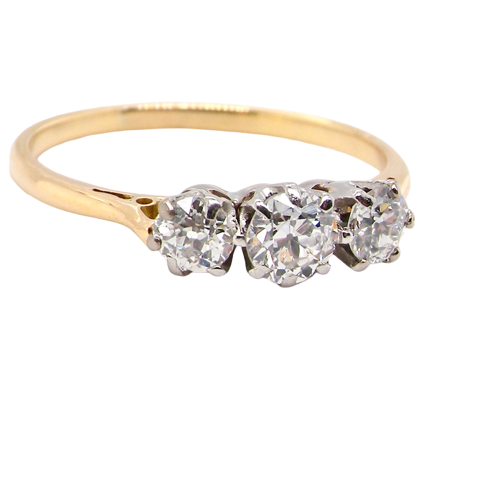 Gold ring with three heart-shaped diamonds on a white background
