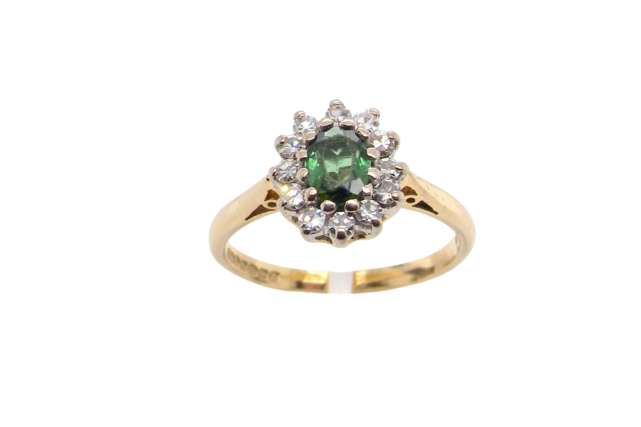 base view An elegant 18 carat gold cluster ring featuring a beautifully proportioned 6 × 4mm green tourmaline