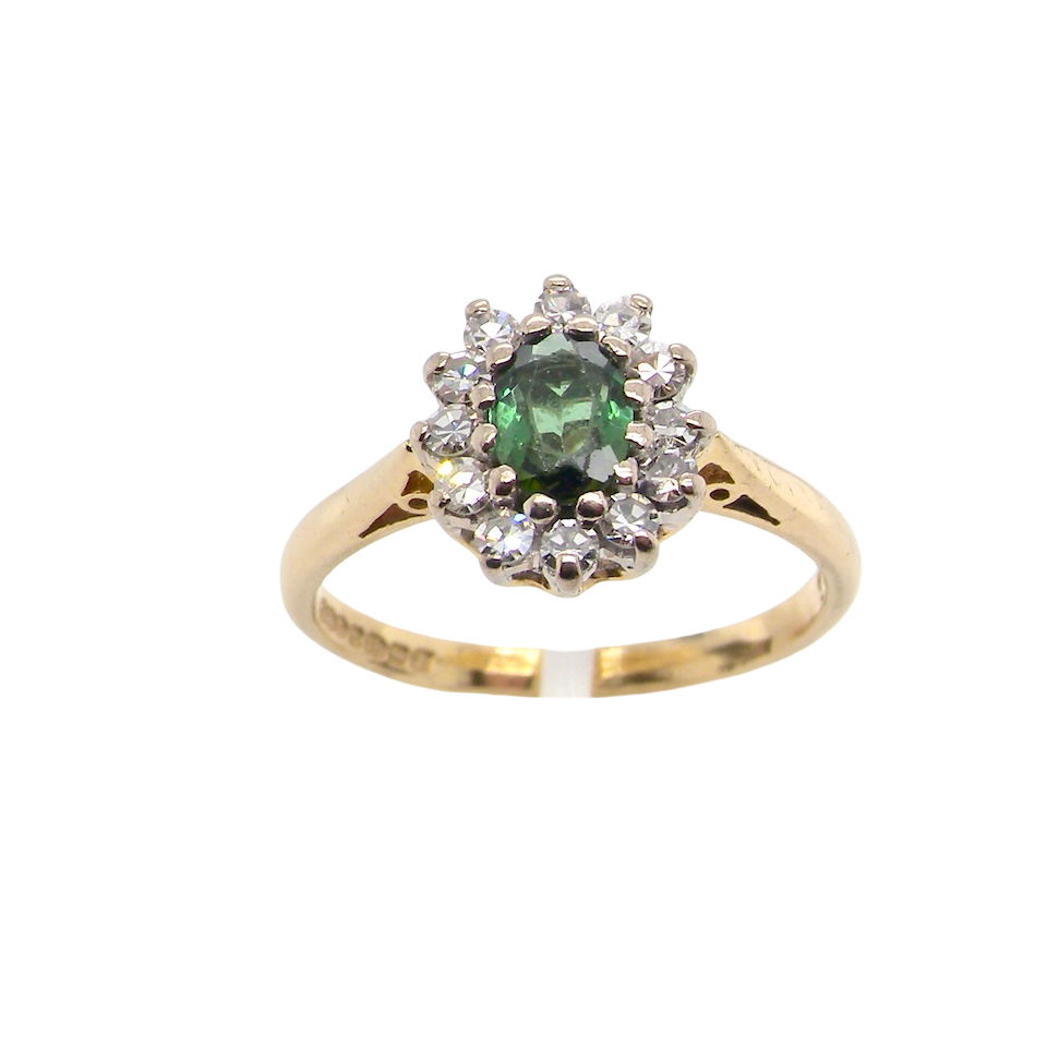 base view An elegant 18 carat gold cluster ring featuring a beautifully proportioned 6 × 4mm green tourmaline