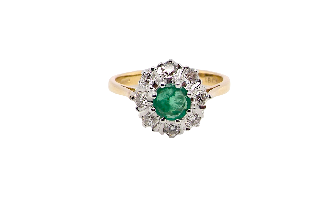 beautiful cluster ring featuring a 6mm round emerald