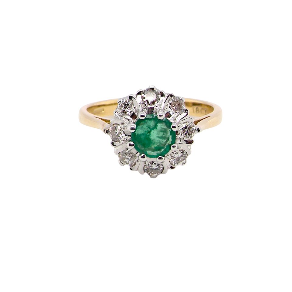 beautiful cluster ring featuring a 6mm round emerald