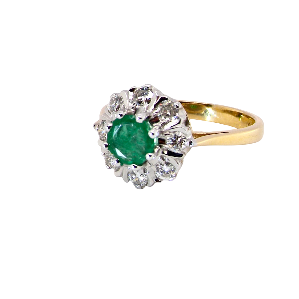 beautiful cluster ring featuring a round emerald