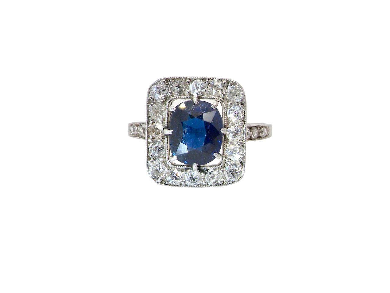 beautiful original Art Deco cluster ring featuring a dark blue oval-cut sapphire