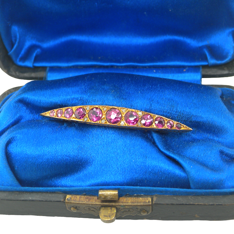 boxed A pretty Victorian crescent shaped brooch. The principal stones are almandine garnets