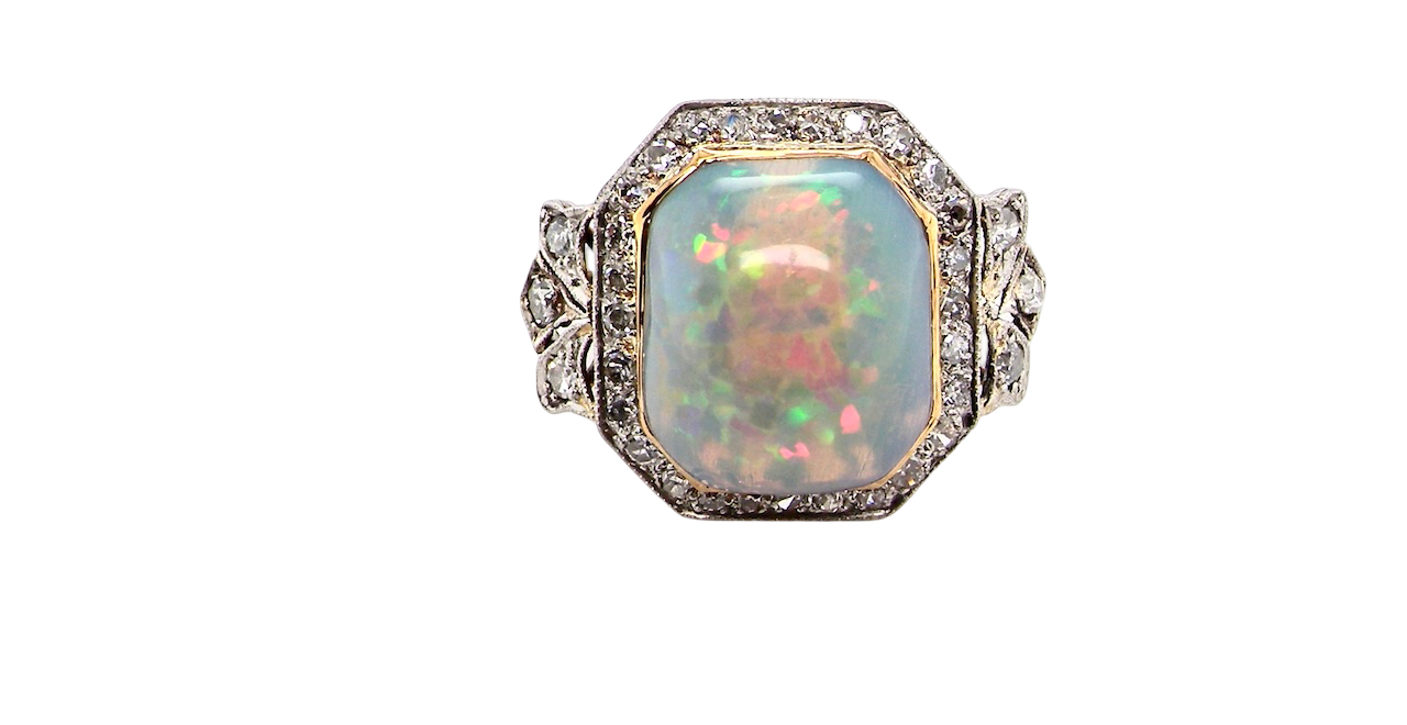 cabouchon cut opal shown is cushion shaped, measures 15x13 (5.78 carats) displaying a mass of vibrant colours, from flashes of fireglow orange, luminous greens, and lavender purples.