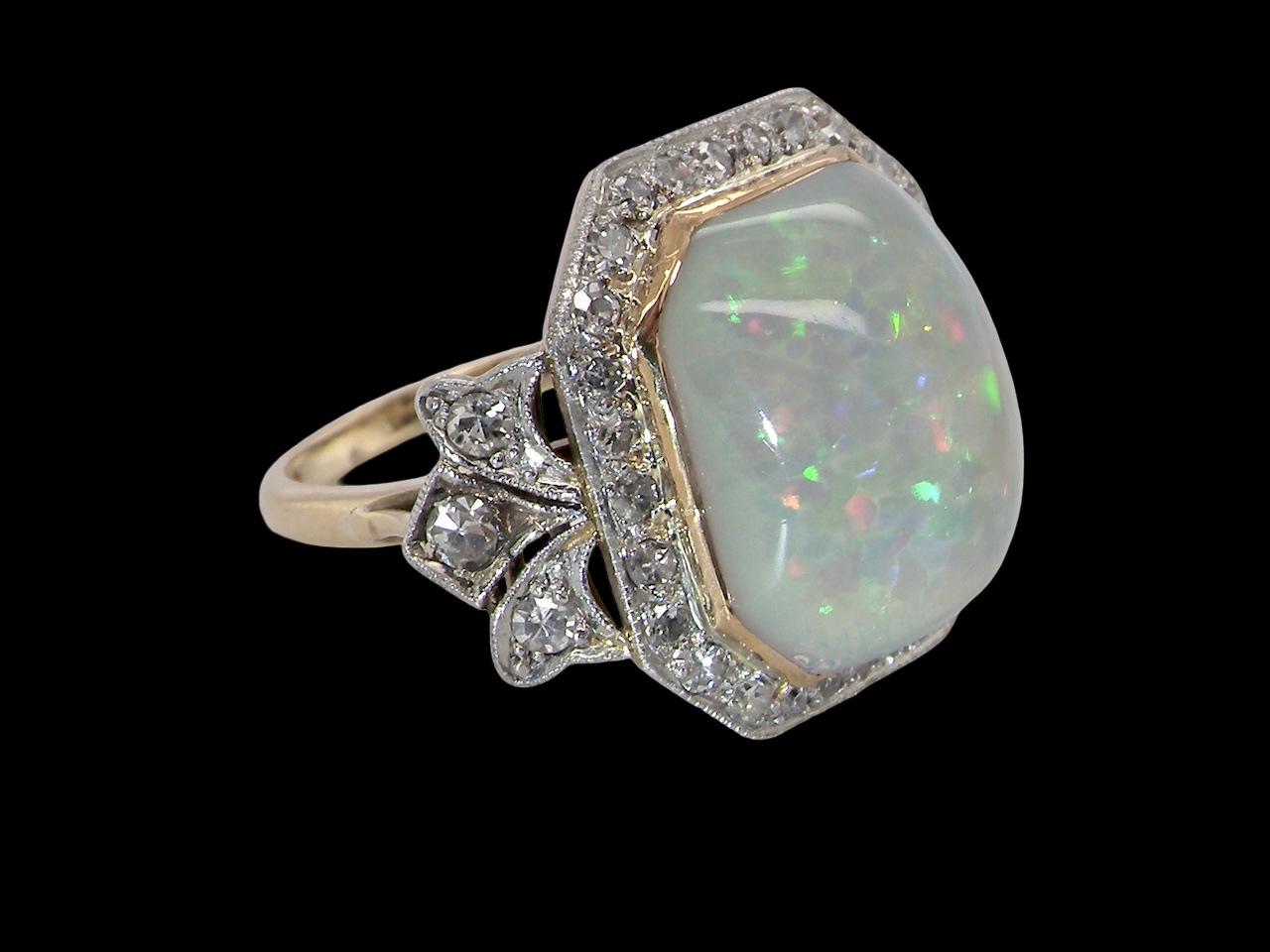 cabouchon cut opal shown is cushion shaped, measures 15x13 (5.78 carats) displaying a mass of vibrant colours, from flashes of fireglow orange, luminous greens, and lavender purples.
from the side