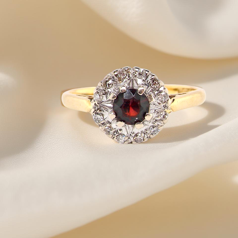 classic 1960s 18 carat yellow gold cluster ring, featuring a garnet