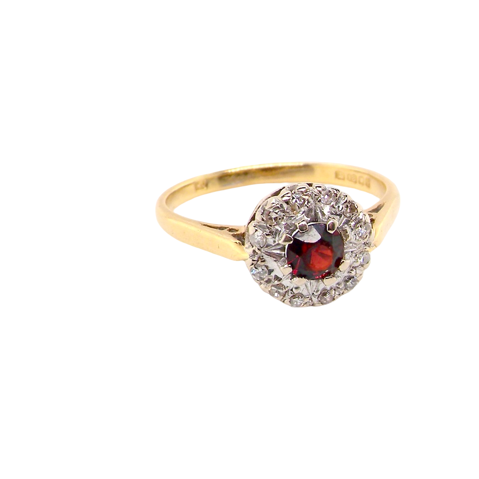 classic 1960s 18 carat yellow gold ring, featuring a round garnet