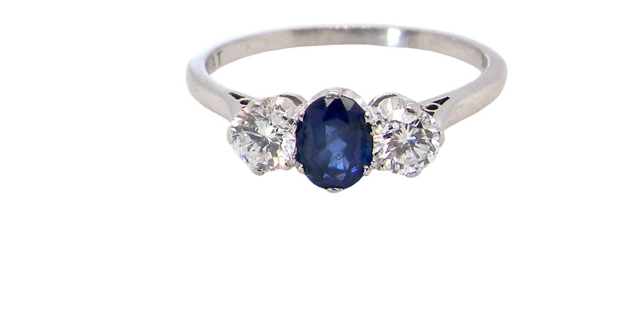 classic trilogy ring set with an exquisite oval cut sapphire centre stone, hues of deep blue colour and measuring 6x4.2mm (