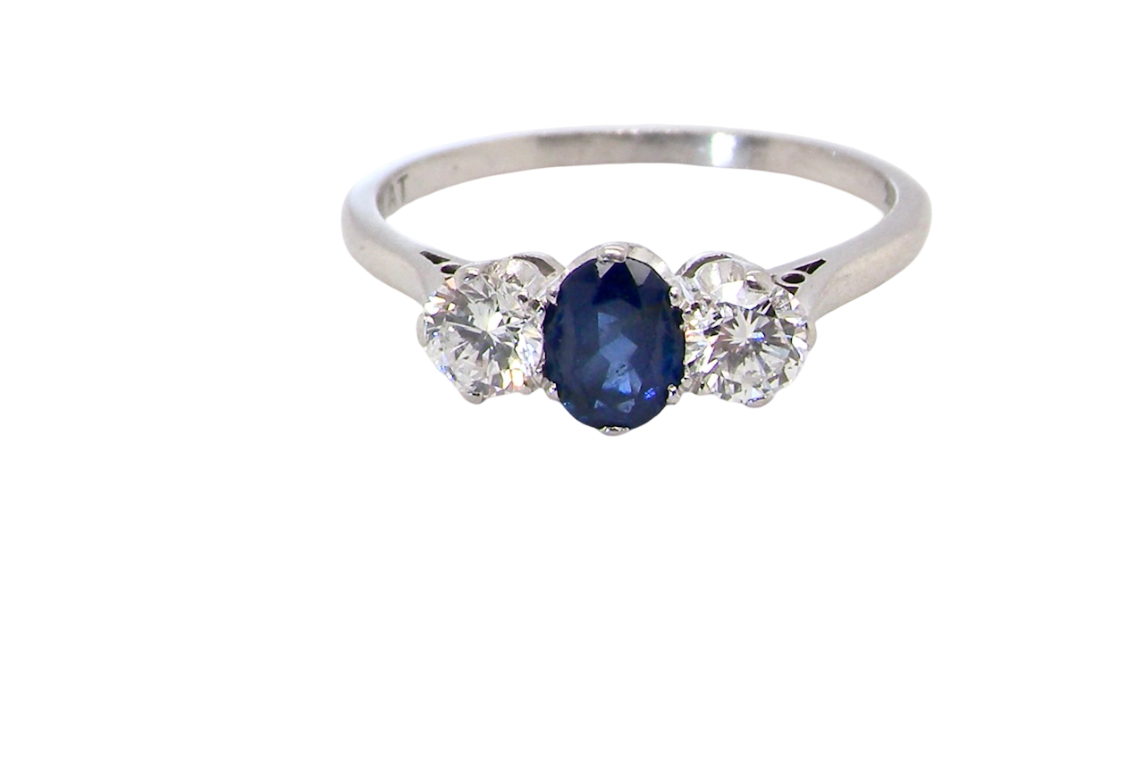 classic trilogy ring set with an exquisite oval cut sapphire centre stone, hues of deep blue colour and measuring 6x4.2mm (