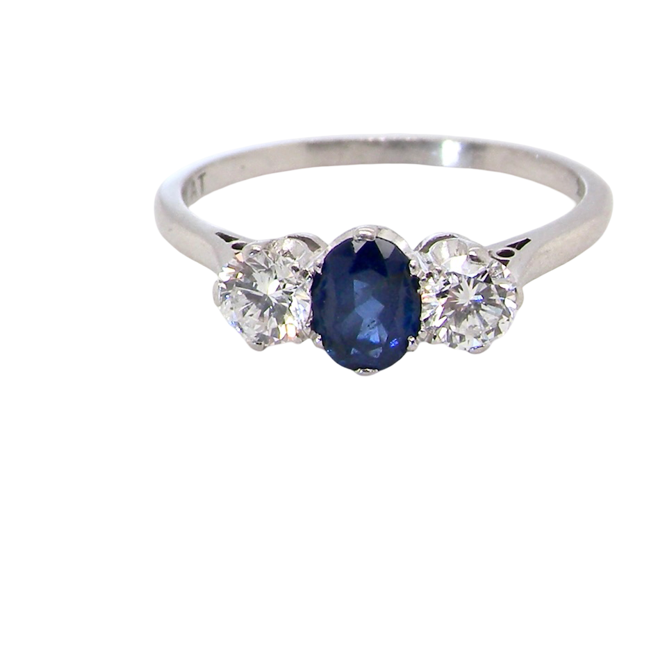 classic trilogy ring set with an exquisite oval cut sapphire centre stone, hues of deep blue colour and measuring 6x4.2mm (