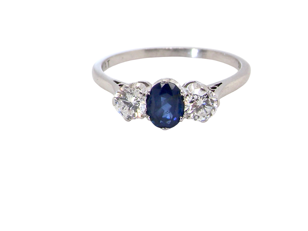 classic trilogy ring set with an exquisite oval cut sapphire centre stone, hues of deep blue colour and measuring 6x4.2mm (