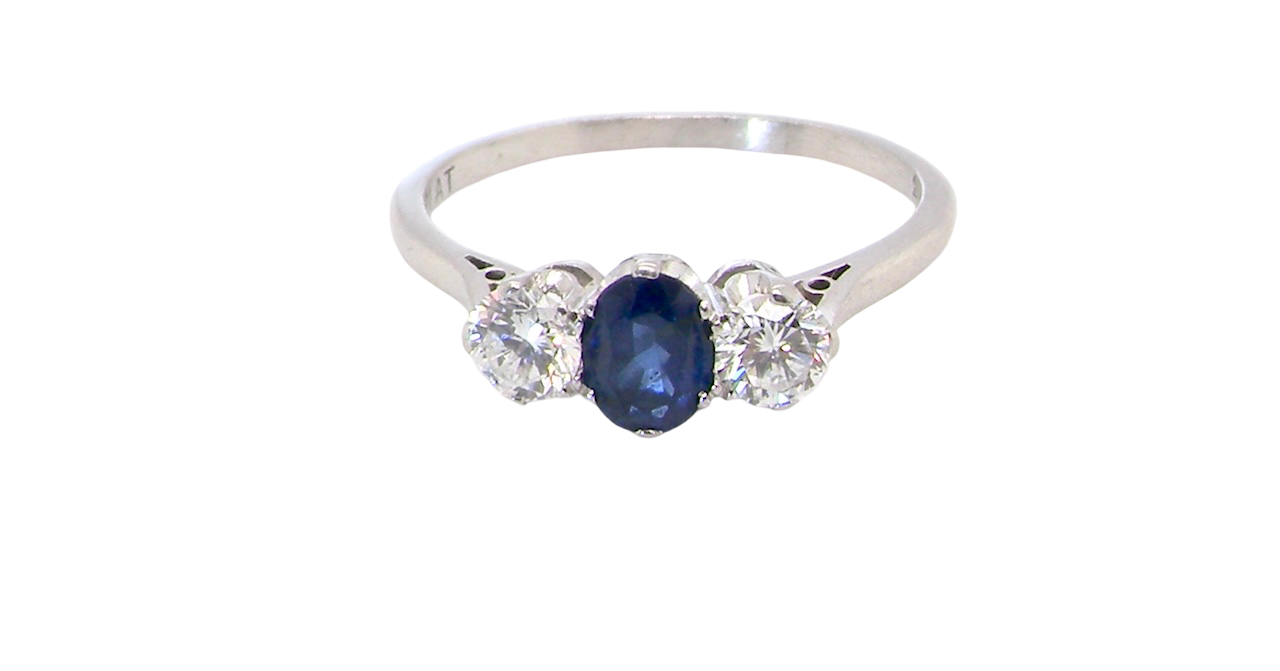 classic trilogy ring set with an exquisite oval cut sapphire centre stone, hues of deep blue colour and measuring 6x4.2mm (est approx 0.50 carats)