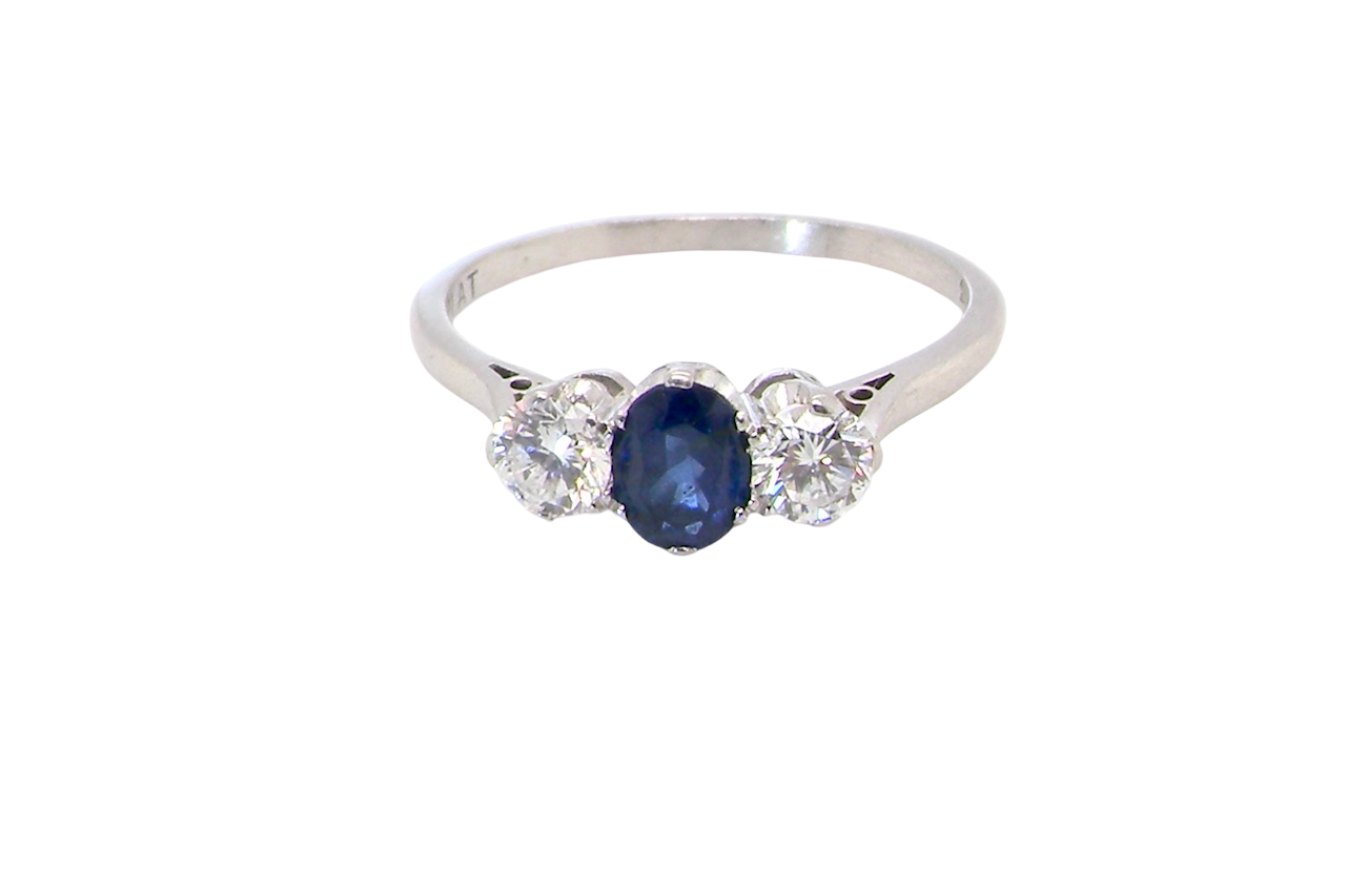 classic trilogy ring set with an exquisite oval cut sapphire centre stone, hues of deep blue colour and measuring 6x4.2mm (est approx 0.50 carats)
