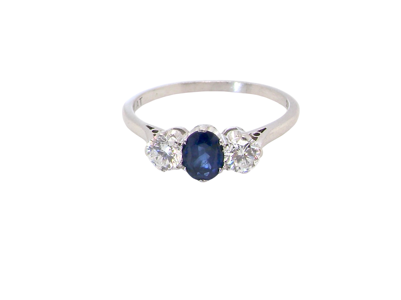 classic trilogy ring set with an exquisite oval cut sapphire centre stone, hues of deep blue colour and measuring 6x4.2mm (est approx 0.50 carats)
