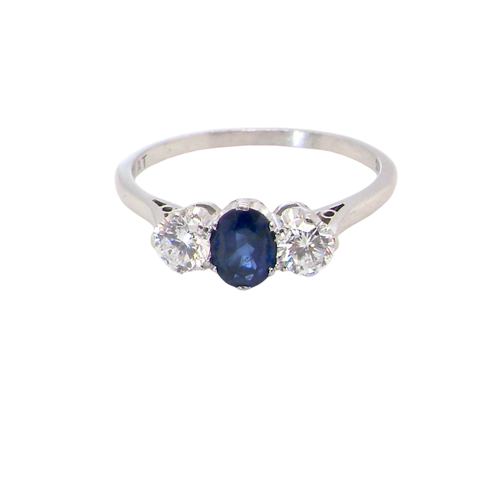 classic trilogy ring set with an exquisite oval cut sapphire centre stone, hues of deep blue colour and measuring 6x4.2mm (est approx 0.50 carats)