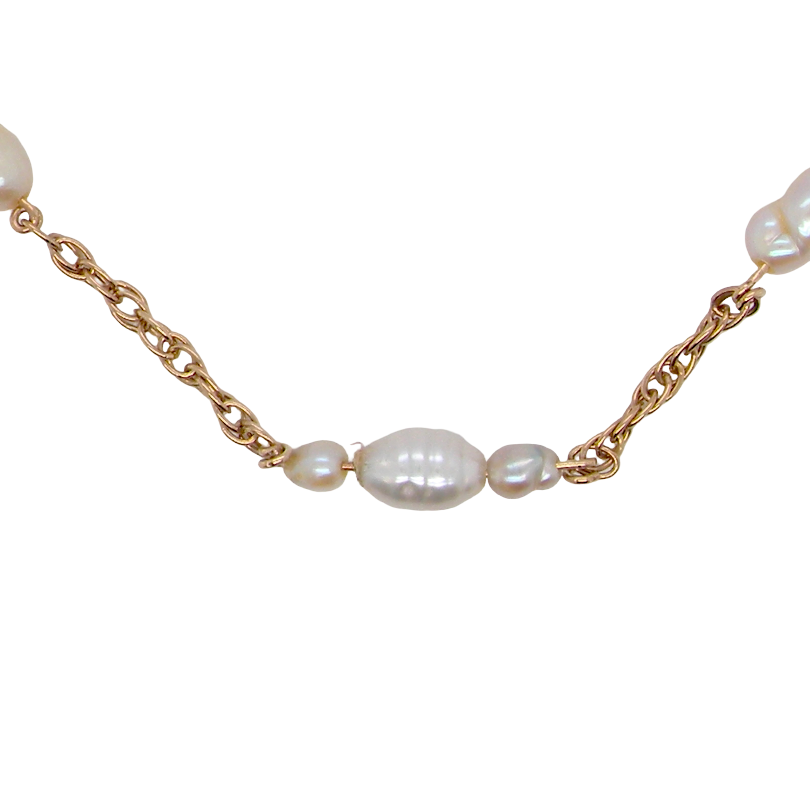 A gold chain necklace featuring irregular white baroque pearls spaced along the chain, shown against a plain white background.