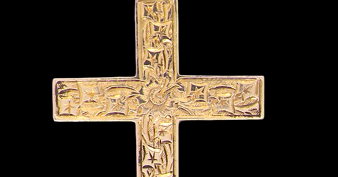 close view A fine 9 carat gold cross. Hand engrarved across the whole body of the cross which measures 45x25mm