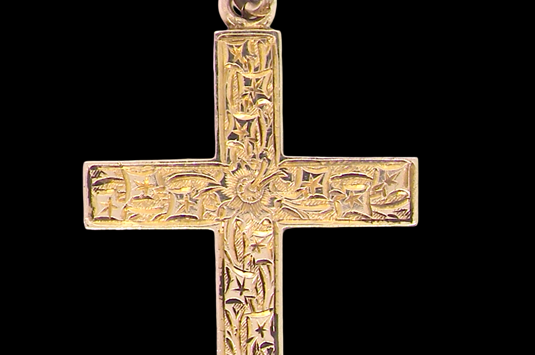 close view A fine 9 carat gold cross. Hand engrarved across the whole body of the cross which measures 45x25mm