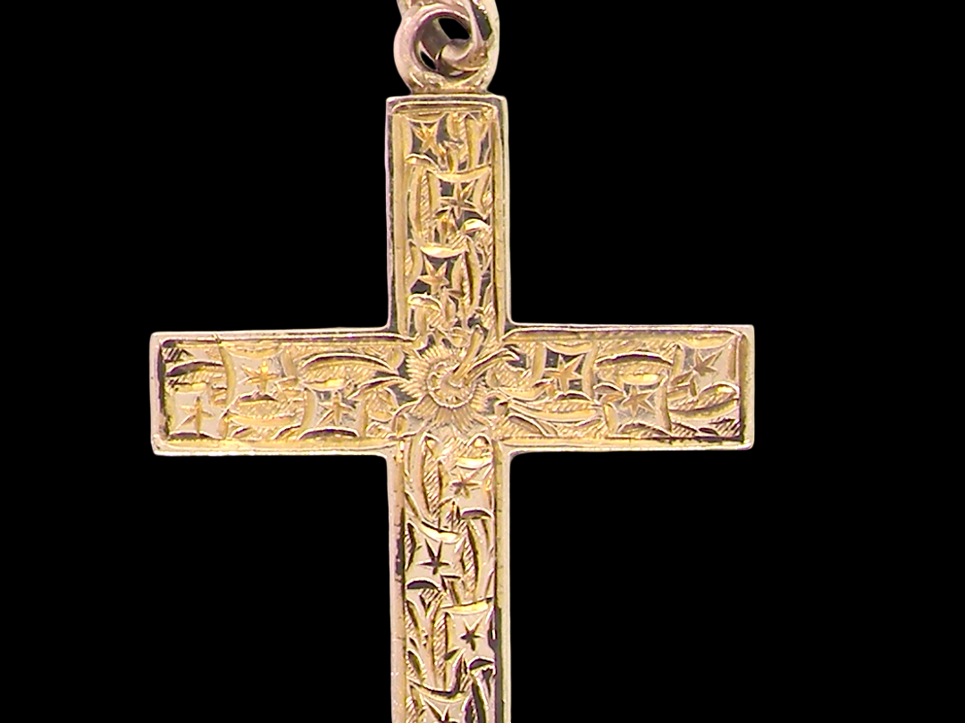 close view A fine 9 carat gold cross. Hand engrarved across the whole body of the cross which measures 45x25mm