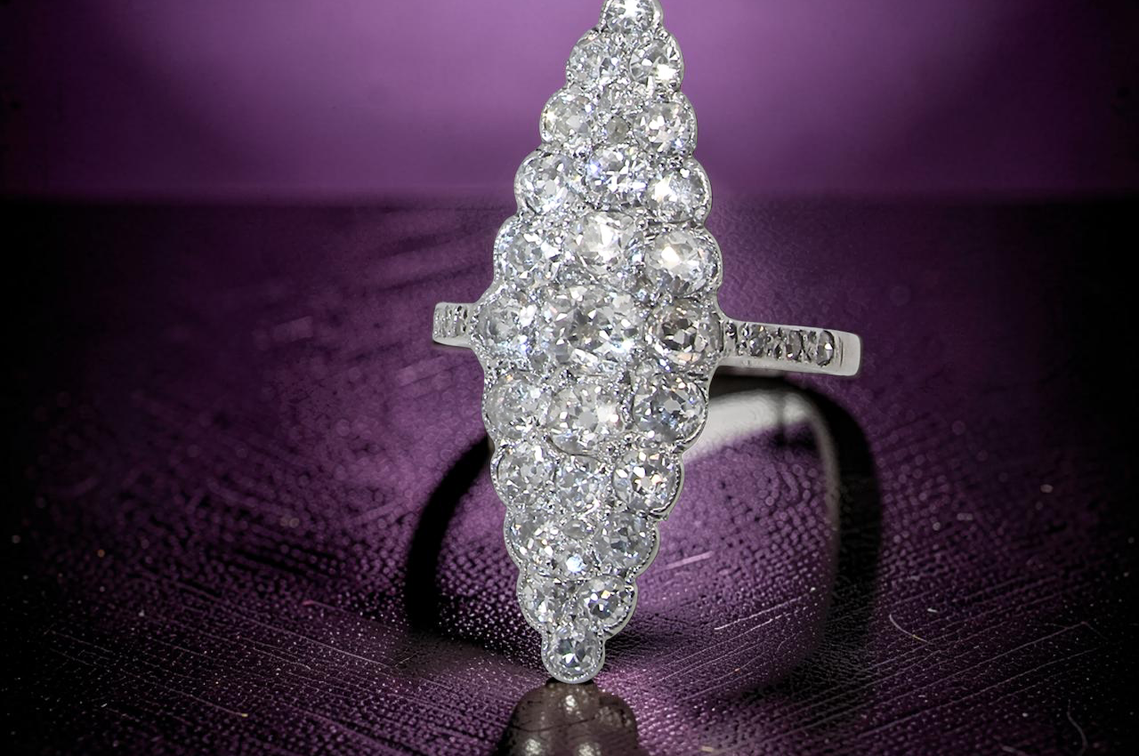 close view This is a striking marquise-shaped diamond cluster ring with a very classic, vintage-inspired look.