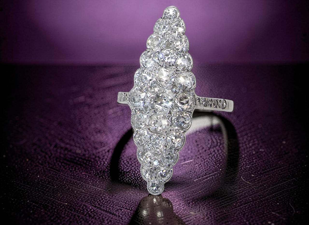 close view This is a striking marquise-shaped diamond cluster ring with a very classic, vintage-inspired look.