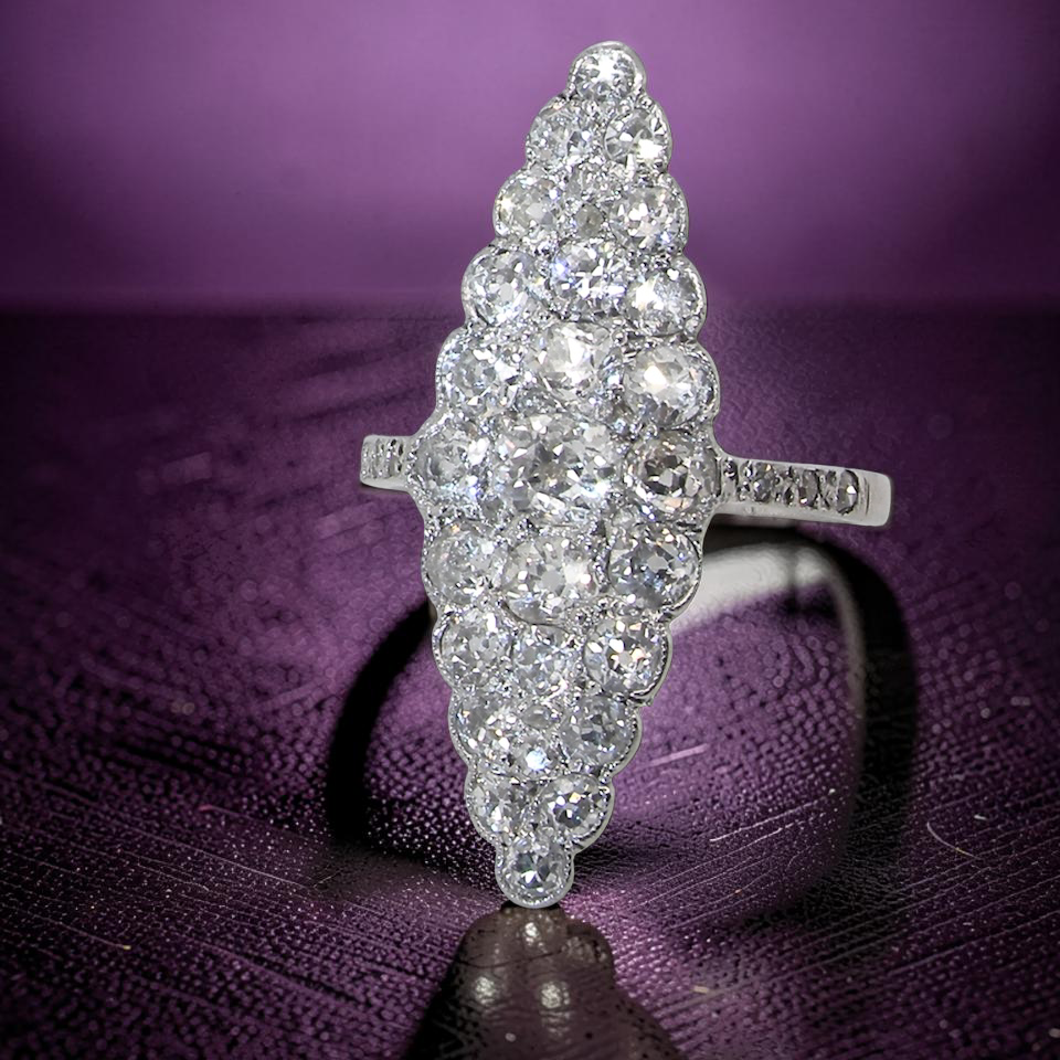 close view This is a striking marquise-shaped diamond cluster ring with a very classic, vintage-inspired look.