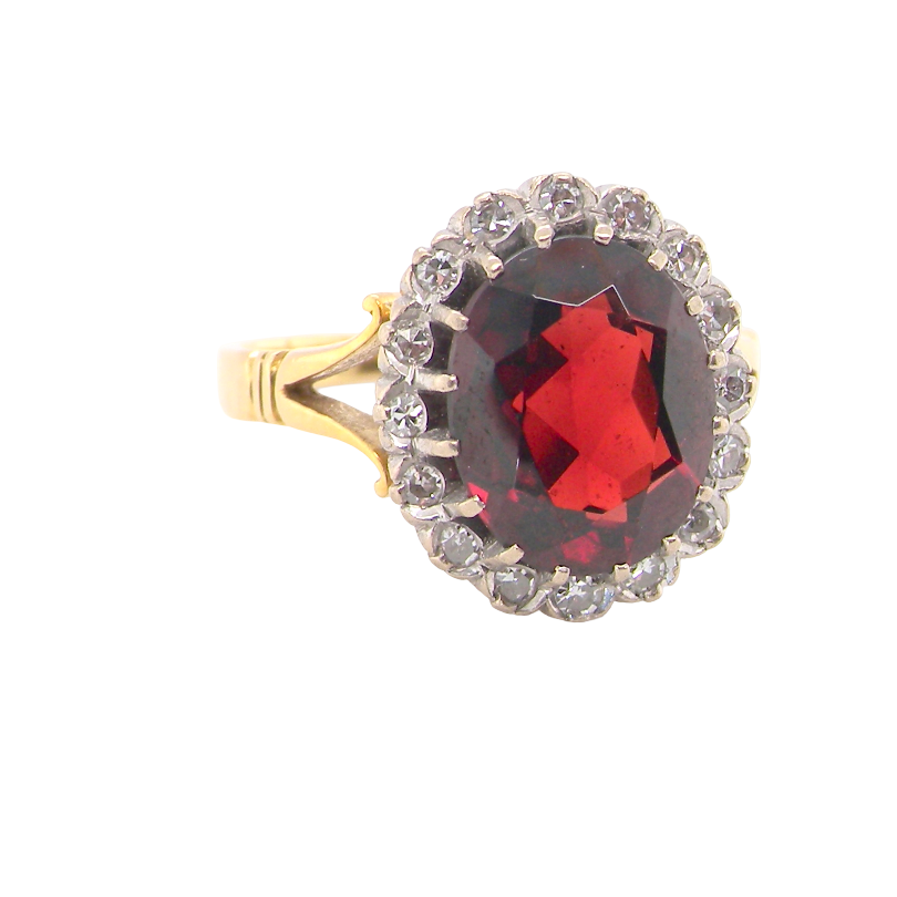 A fine cluster ring. Features a large garnet centre stone
Complimented by an outer halo of brilliant cut diamonds. 