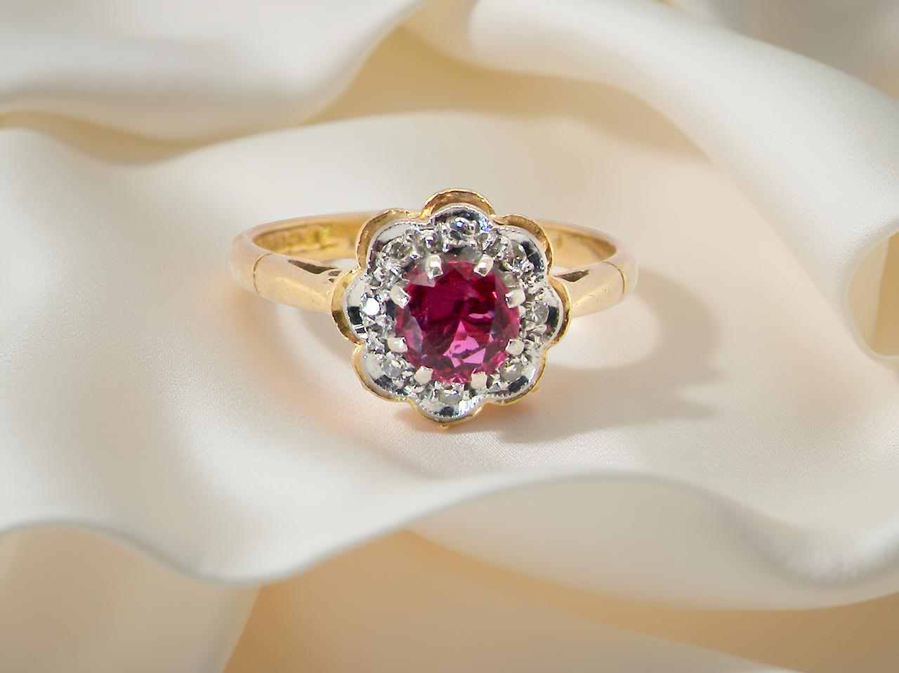 cluster ring centred around a 5 mm ruby,( 0.50 carats)