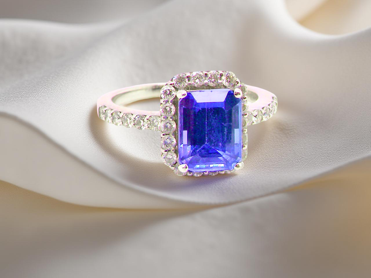 cluster ring featuring a 4A quality Tanzanite as its centre stone. B