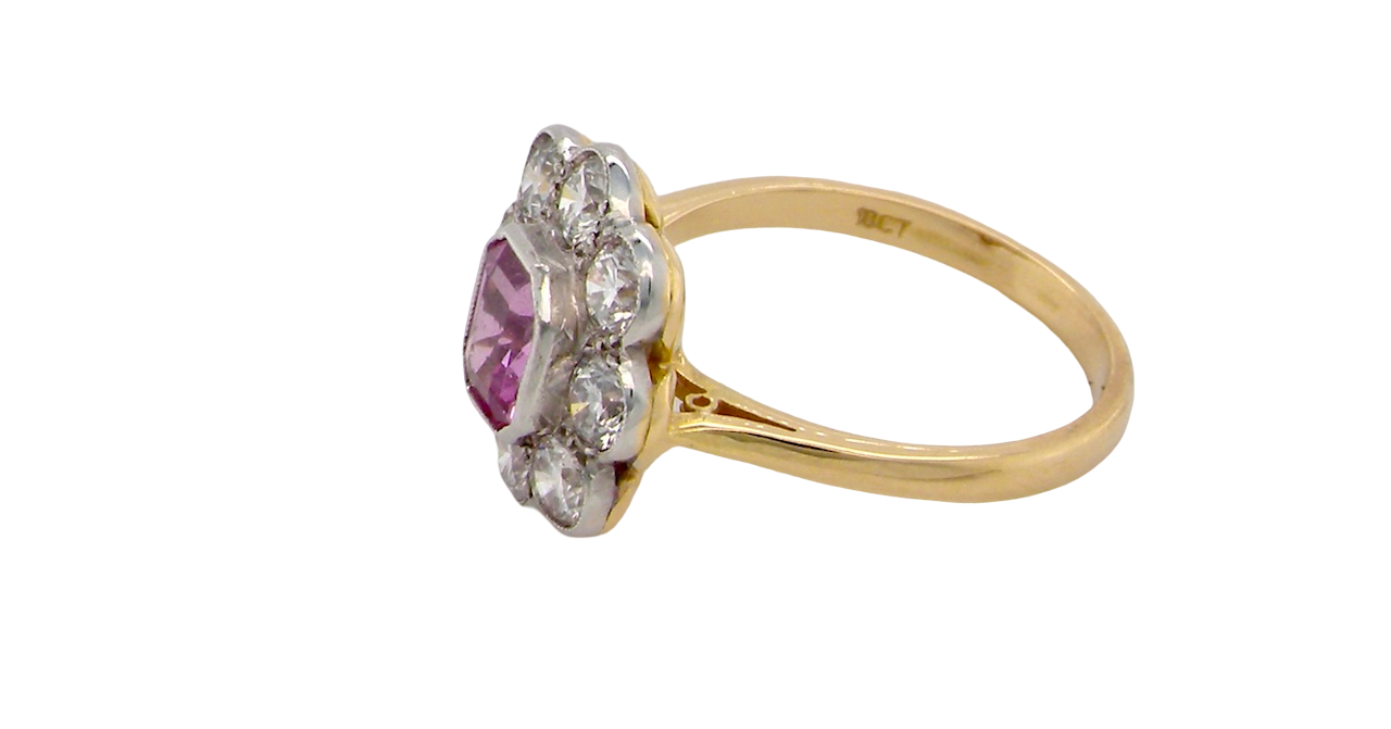 A cluster ring featuring a beautiful cushion-cut pink sapphire side
