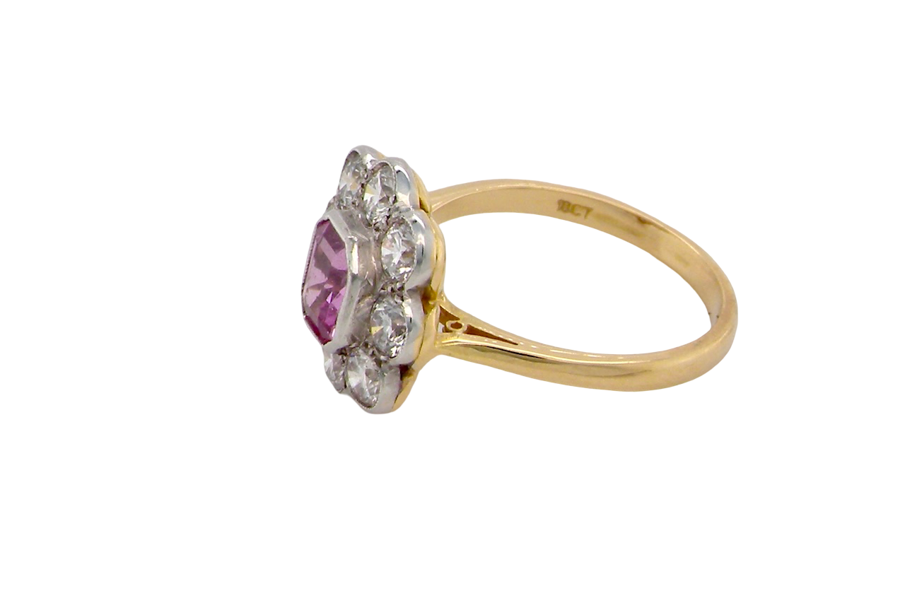 A cluster ring featuring a beautiful cushion-cut pink sapphire side