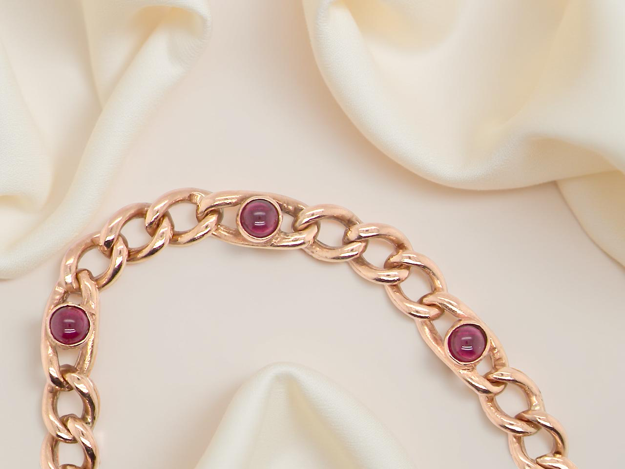 A vintage curb bracelet set with garnets