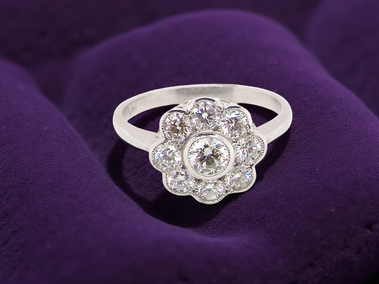 vintage cluster ring crafted in platinum* and set with a diamond centre stone, 0.25ct