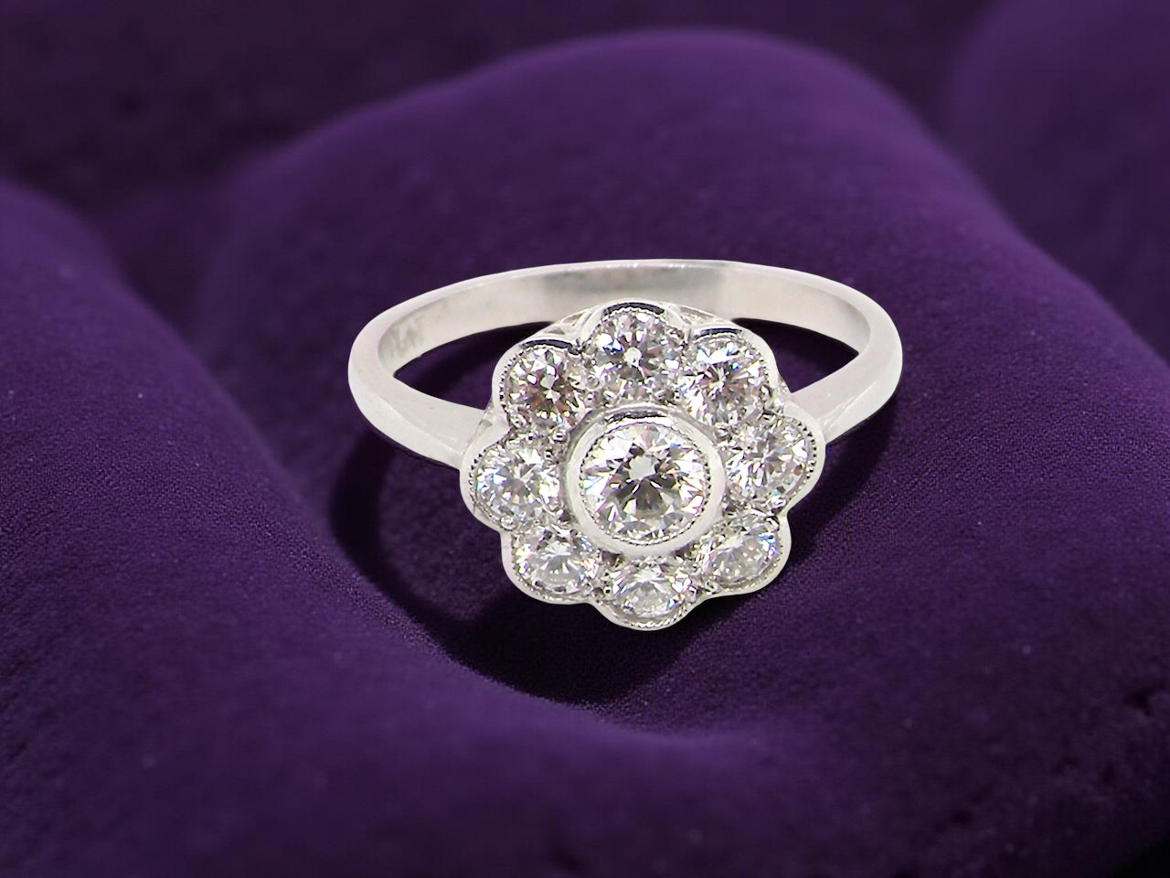 vintage cluster ring crafted in platinum* and set with a diamond centre stone, 0.25ct