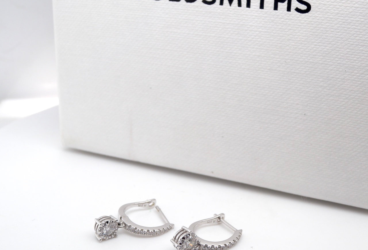 A pair of diamond hoop and drop earrings