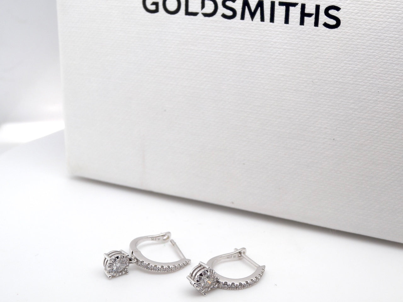 A pair of diamond hoop and drop earrings