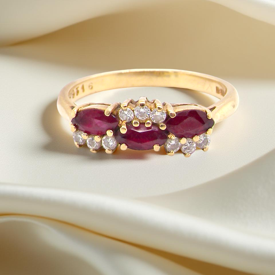 diamond ring with marquise-cut rubies (5×3 mm each).