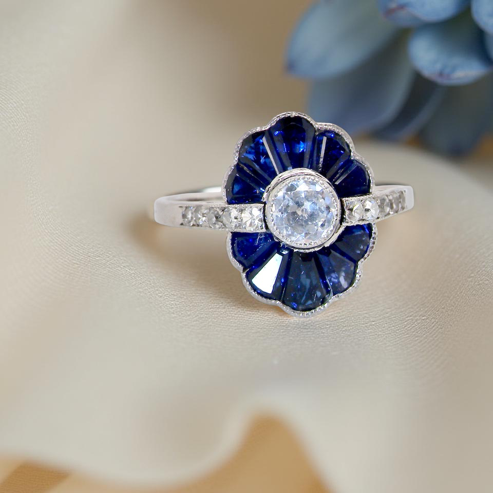 cluster ring featuring a distinctive fan-shaped design.